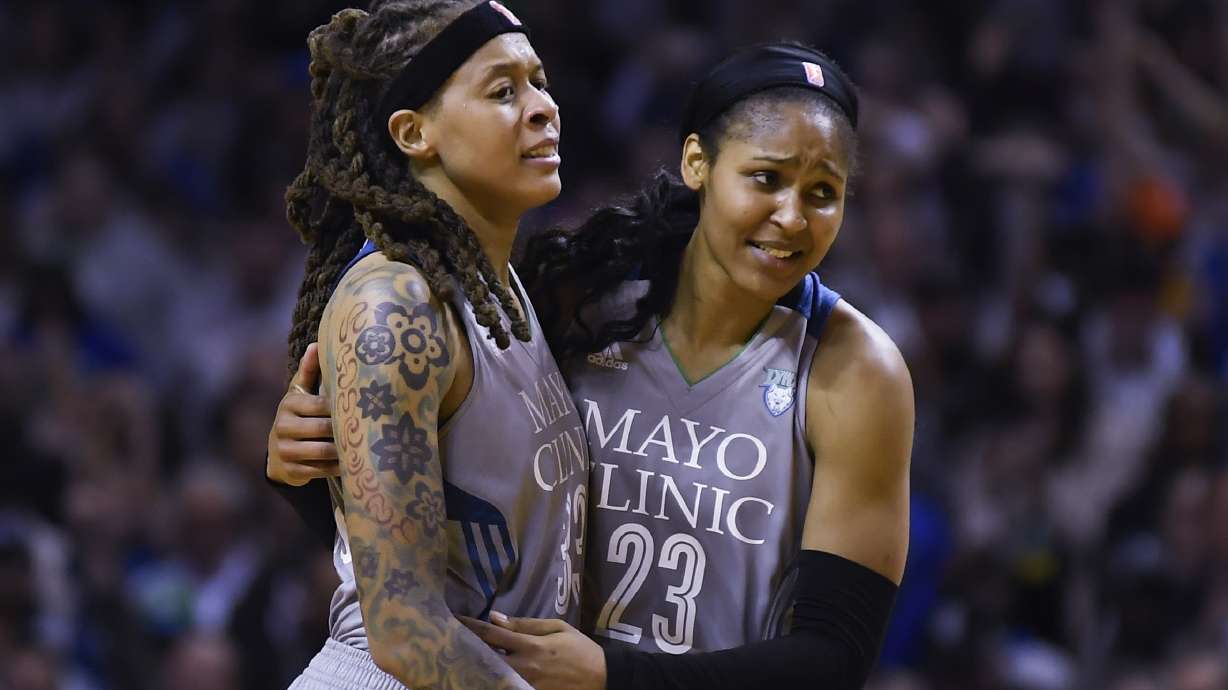 FILE - Minnesota Lynx guard Seimone Augustus (33) and forward Maya Moore (23) embrace after Game 5 of the team's WNBA Finals against the Los Angeles Sparks, Oct. 4, 2017 in Minneapolis. The Women’s Basketball Hall of Fame had a huge Minnesota feel to it with the induction of Moore and Augustus getting enshrined on Saturday, April 25, 2024.