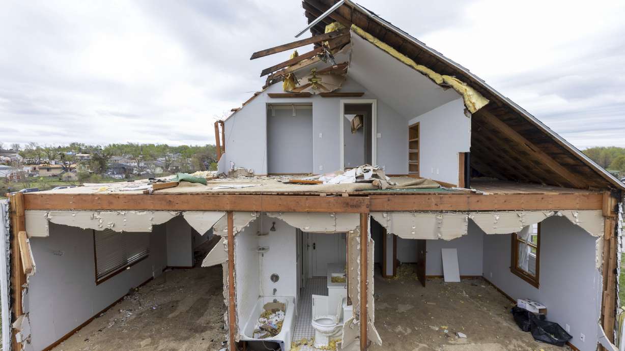 A partially torn off roof is seen on a damaged home in Omaha, Neb., on Saturday. Dozens of reported tornadoes wreaked havoc Friday in the Midwest.