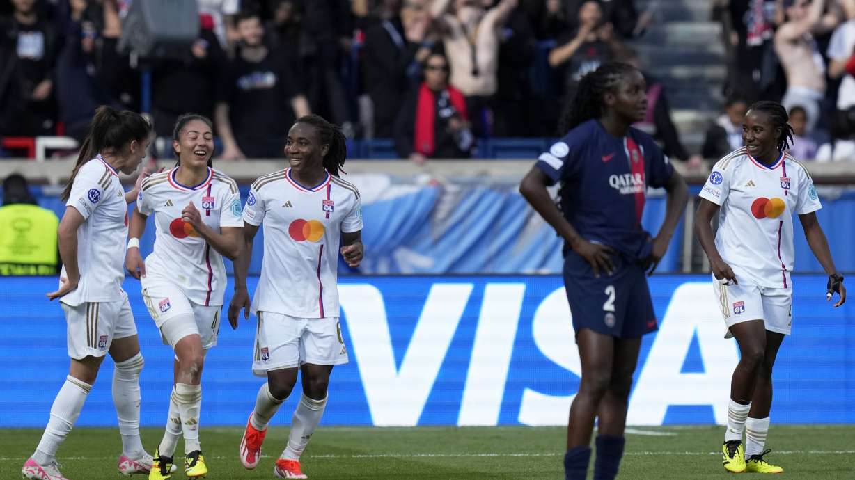 Lyon's Melchie Dumornay, center, celebrates with Selma Bacha and Amel Majri, left, after scoring her side's second goal during the women's Champions League semifinal, second leg, soccer match between Paris Saint-Germain and Olympique Lyonnais at Parc des Princes, in Paris, Sunday, April 28, 2024.