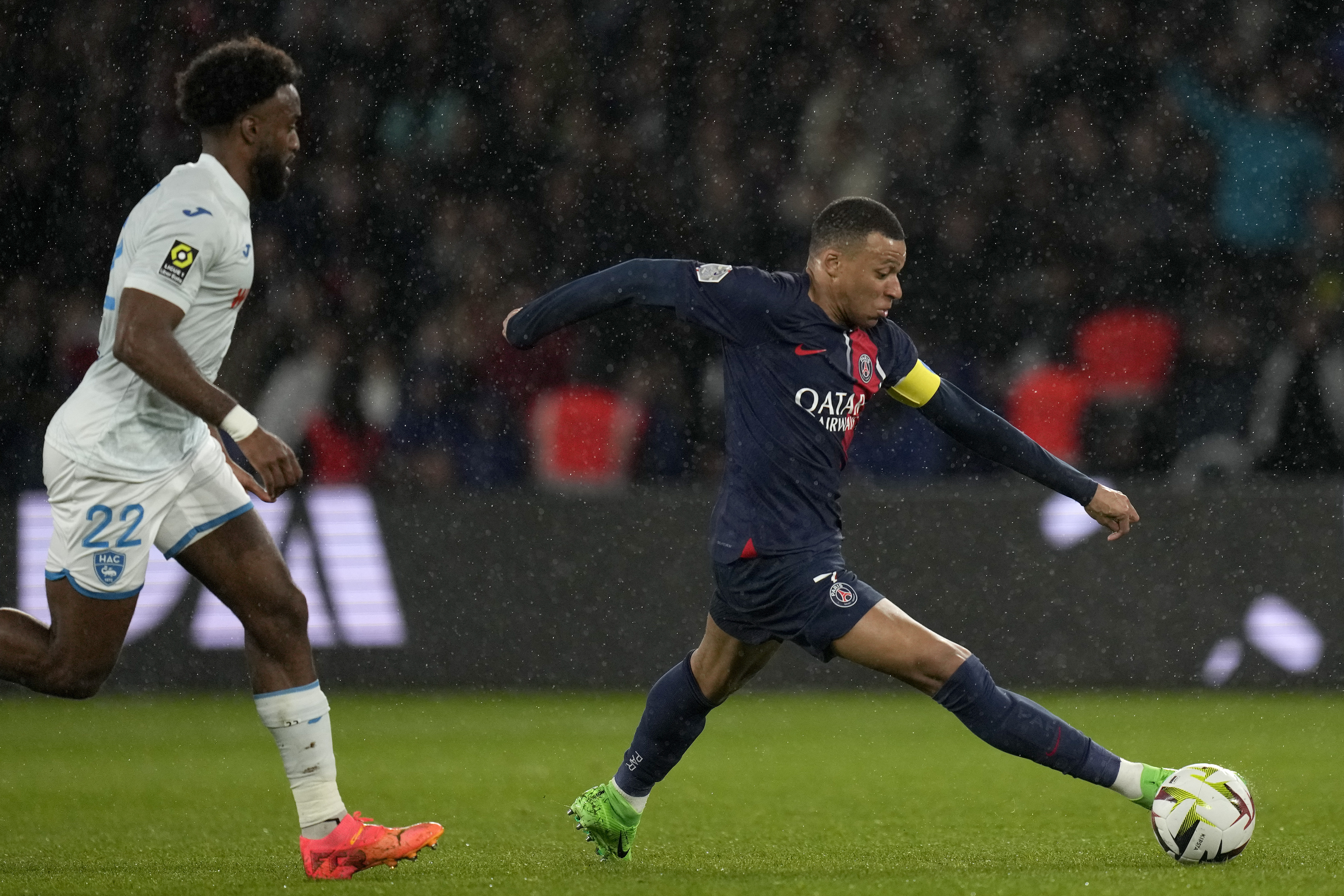 PSG's Kylian Mbappe gets away from Le Havre's Yoann Salmier during the French League One soccer match between Paris Saint-Germain and Le Havre at the Parc des Princes in Paris, Saturday, April 27, 2024.