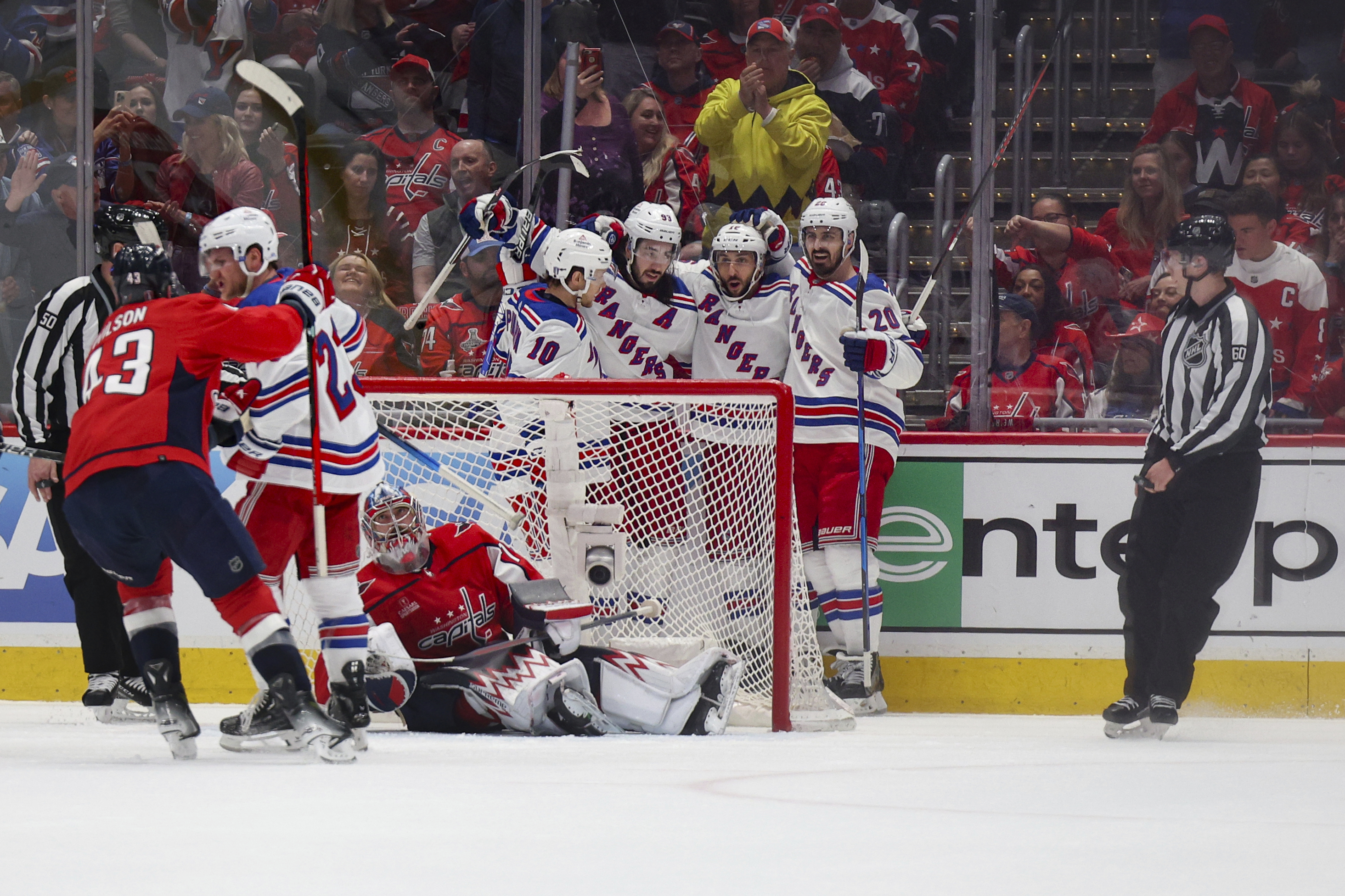 New York Rangers players celebrate after scoring against the Washington Capitals during the first period in Game 4 of an NHL hockey Stanley Cup first-round playoff series, Sunday April 28, 2024, in Washington.