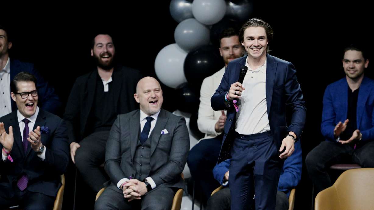 Members of the team react as Clayton Keller introduces himself to the fans during the NHL event at the Delta Center in Salt Lake City, as Utah’s NHL hockey team is introduced to fans on Wednesday, April 24, 2024.