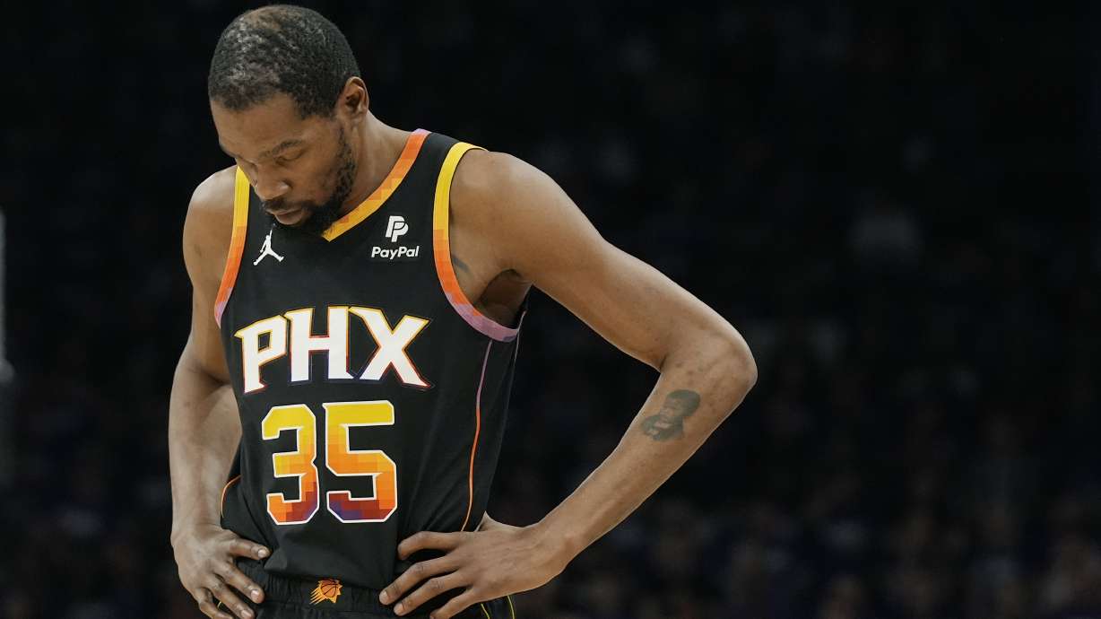 Phoenix Suns forward Kevin Durant pauses on the court during the first half of Game 4 of an NBA basketball first-round playoff series against the Minnesota Timberwolves, Sunday, April 28, 2024, in Phoenix. The Timberwolves won 122-116, taking the series 4-0.
