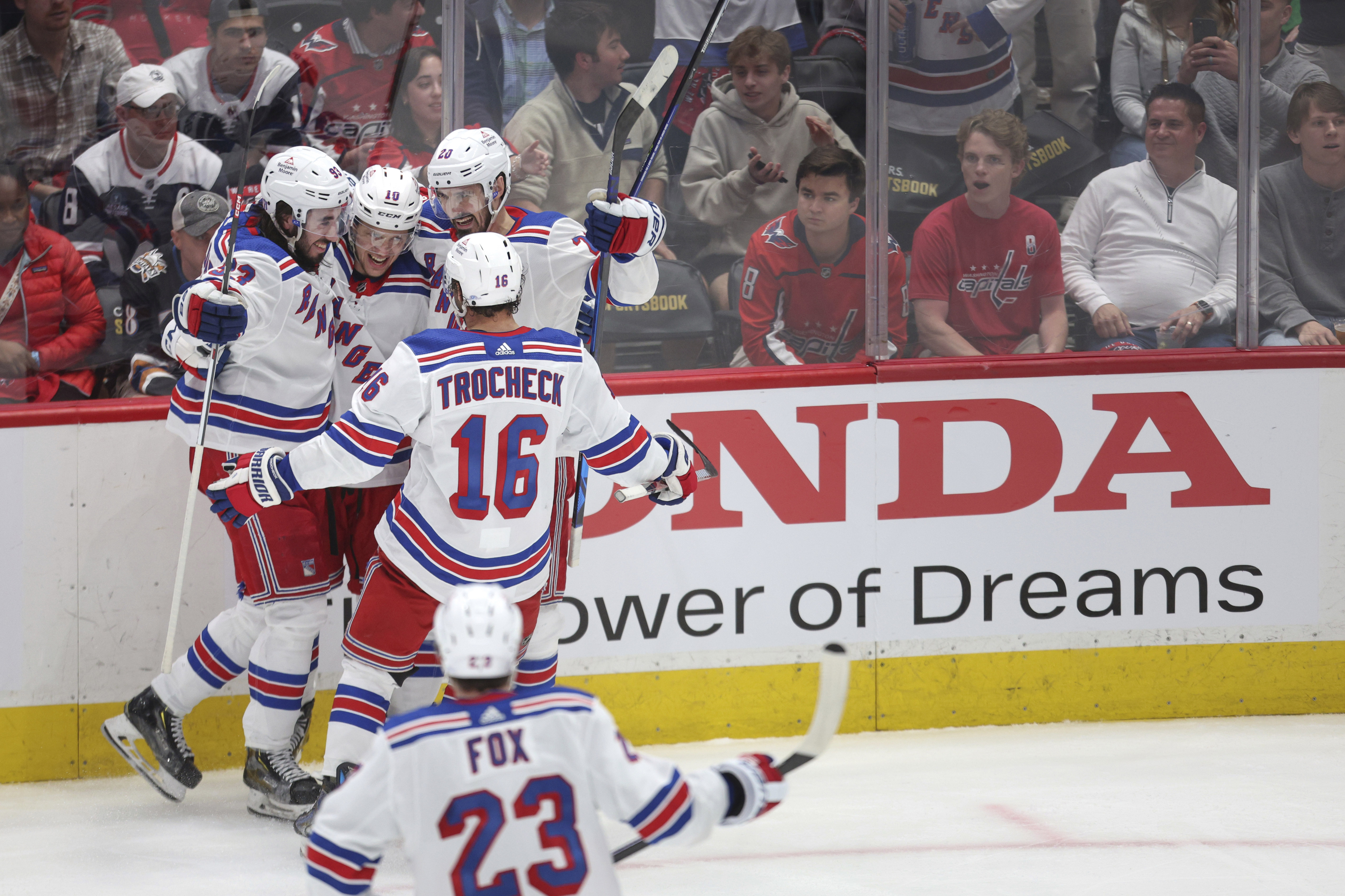 New York Rangers left wing Artemi Panarin, center, celebrates with teammates after scoring a goal during the third period in Game 4 of an NHL hockey Stanley Cup first-round playoff series against the Washington Capitals, Sunday, April 28, 2024, in Washington.