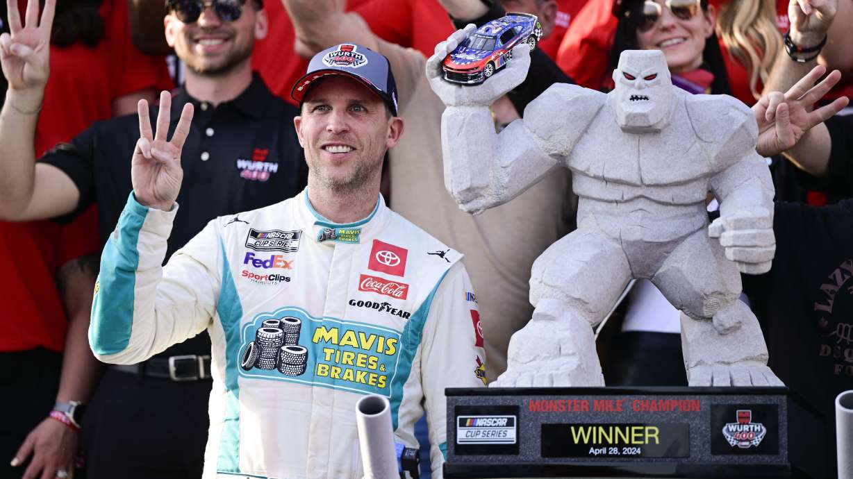 Denny Hamlin, front left, celebrates in Victory Lane after winning a NASCAR Cup Series auto race at Dover Motor Speedway, Sunday, April 28, 2024, in Dover, Del.