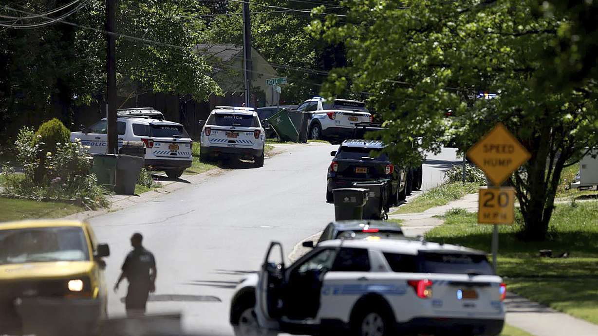 Police work at the scene of a shooting Monday, in east Charlotte, N.C. Officers from the U.S. Marshals Task Force were conducting an investigation in a suburban neighborhood when they were fired upon, police said in a post on X.
