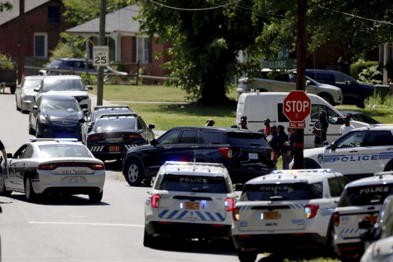 Multiple law enforcement vehicles respond in the neighborhood where several officers on a task force trying to serve a warrant were shot in Charlotte, N.C., Monday.