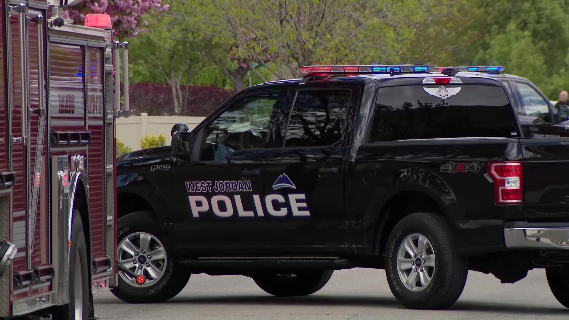 A West Jordan police car blocks the road leading to a West Jordan home after a fake call to 911.