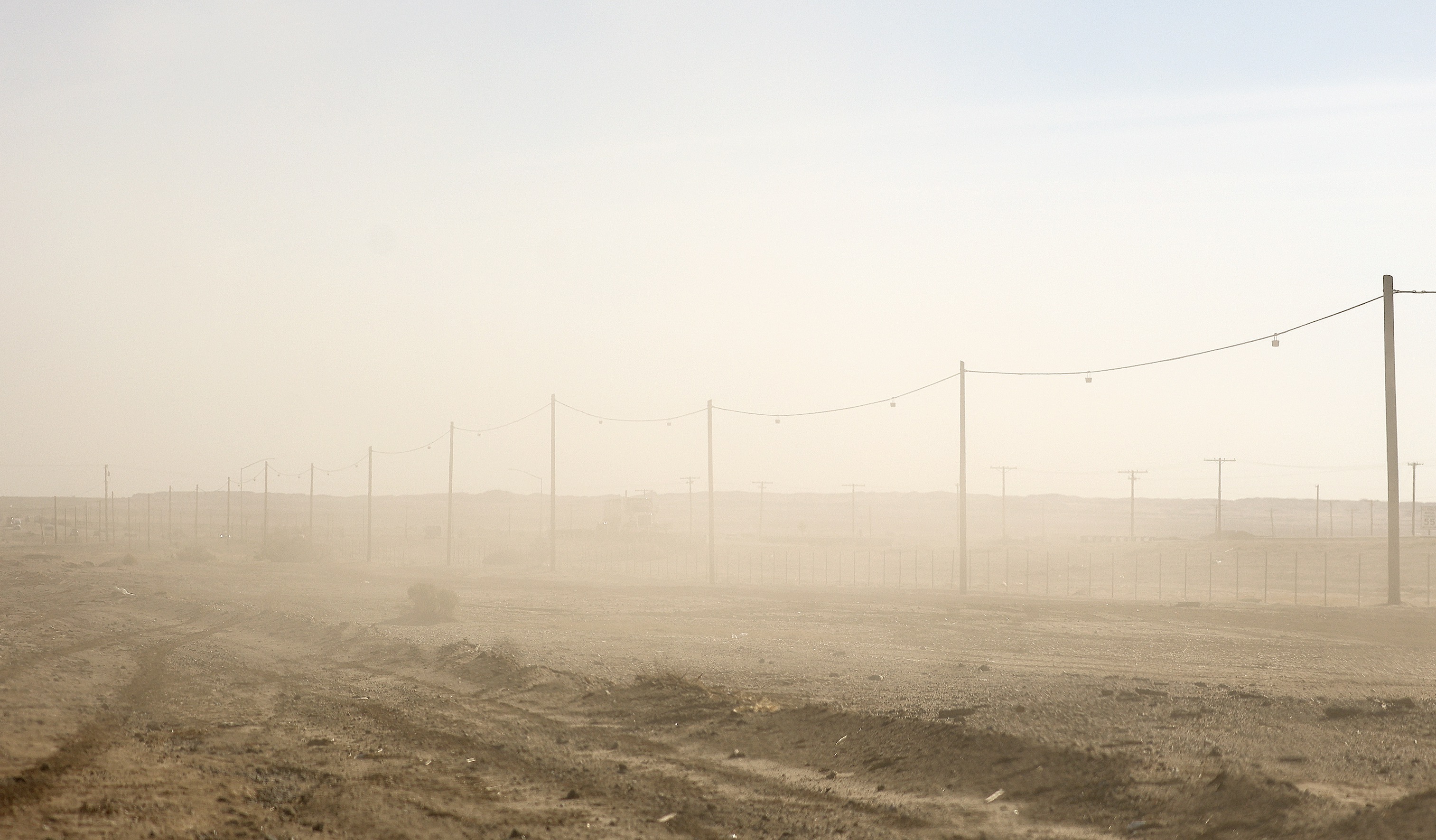 Dust lingers after off-highway vehicles drove by in West Shores, Calif., on Dec. 15, 2023.