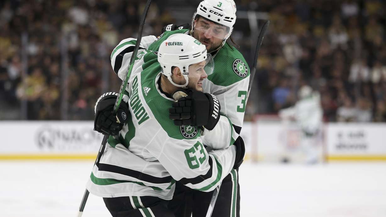 Dallas Stars right wing Evgenii Dadonov (63) and defenseman Chris Tanev (3) celebrate after Dadonov's goal during the first period against the Vegas Golden Knights in Game 4 of an NHL hockey Stanley Cup first-round playoff series Monday, April 29, 2024, in Las Vegas.