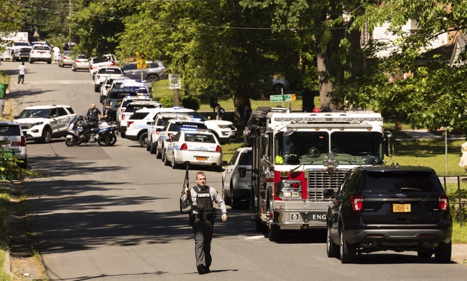 Multiple law enforcement vehicles respond in the neighborhood where several officers on a task force trying to serve a warrant were shot in Charlotte, N.C., Monday.