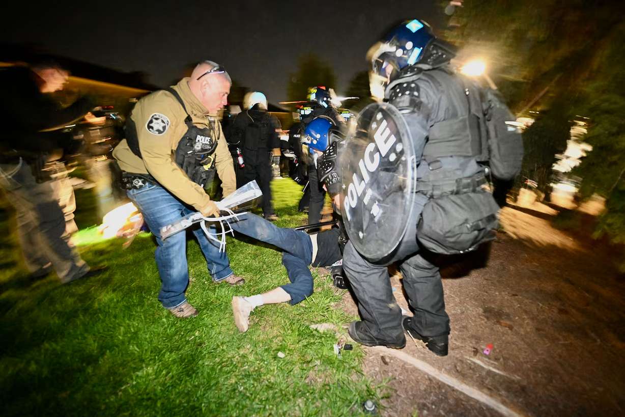 Police break up the demonstrators gathered at the University of Utah to show support for Palestine in Salt Lake City on Monday.