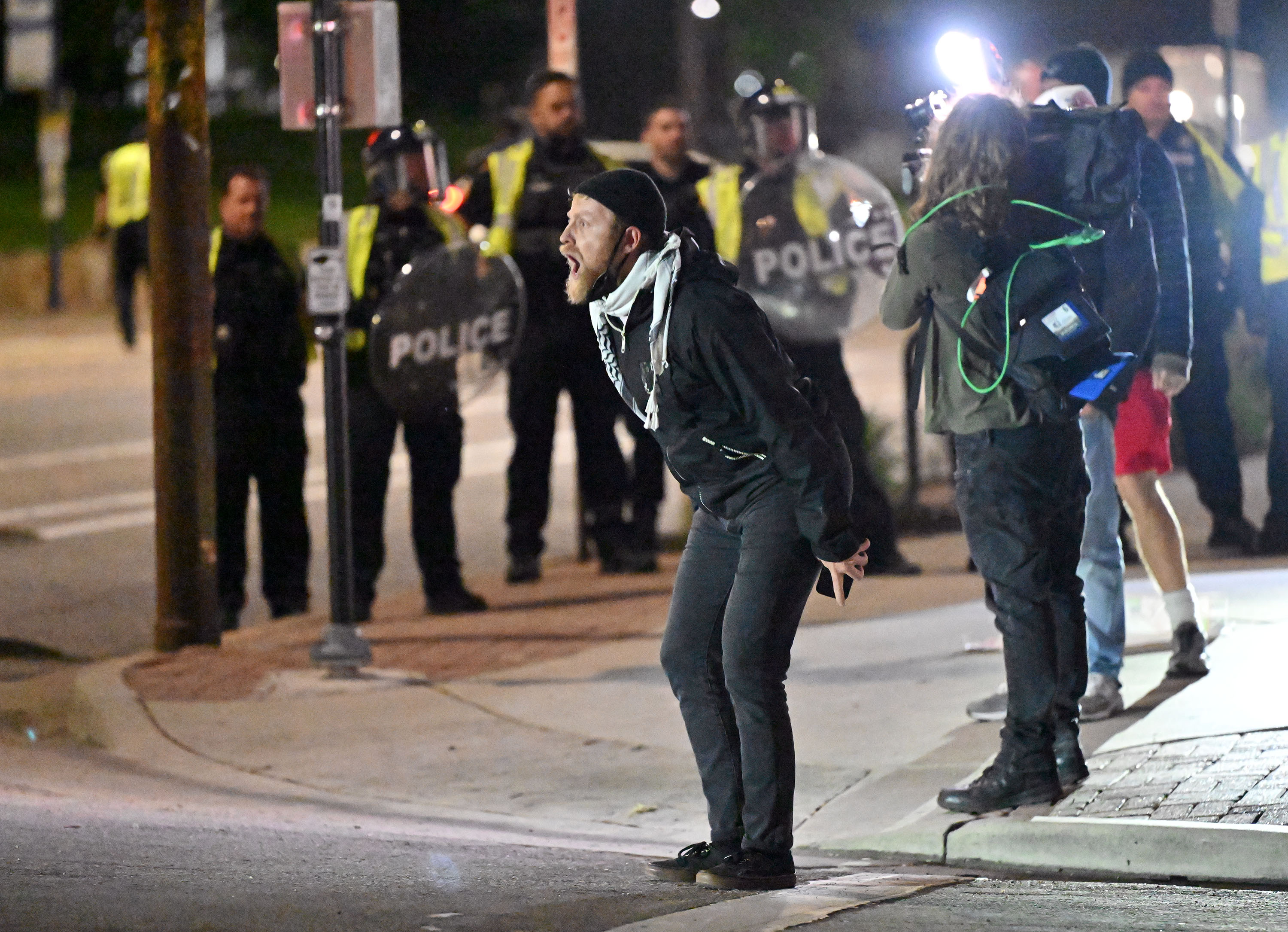 A demonstrator taunts the police as they move in and make arrests on demonstrators gathered to show support for Palestine at the University of Utah in Salt Lake City on Monday.