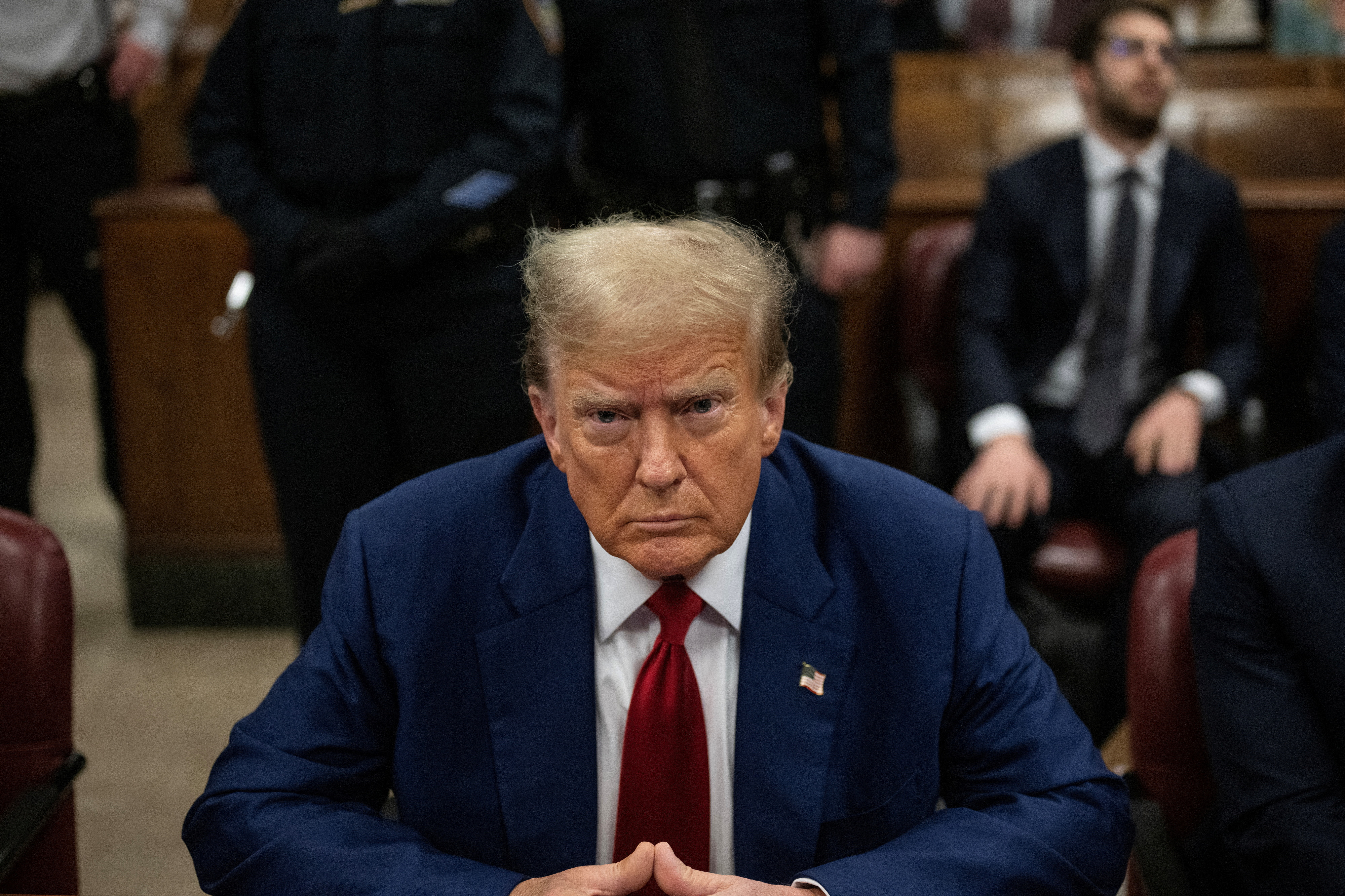 Former president Donald Trump sits in the courtroom at Manhattan criminal court, Tuesday in New York. The judge overseeing Trump's criminal hush money trial fined him $9,000 for contempt of court.