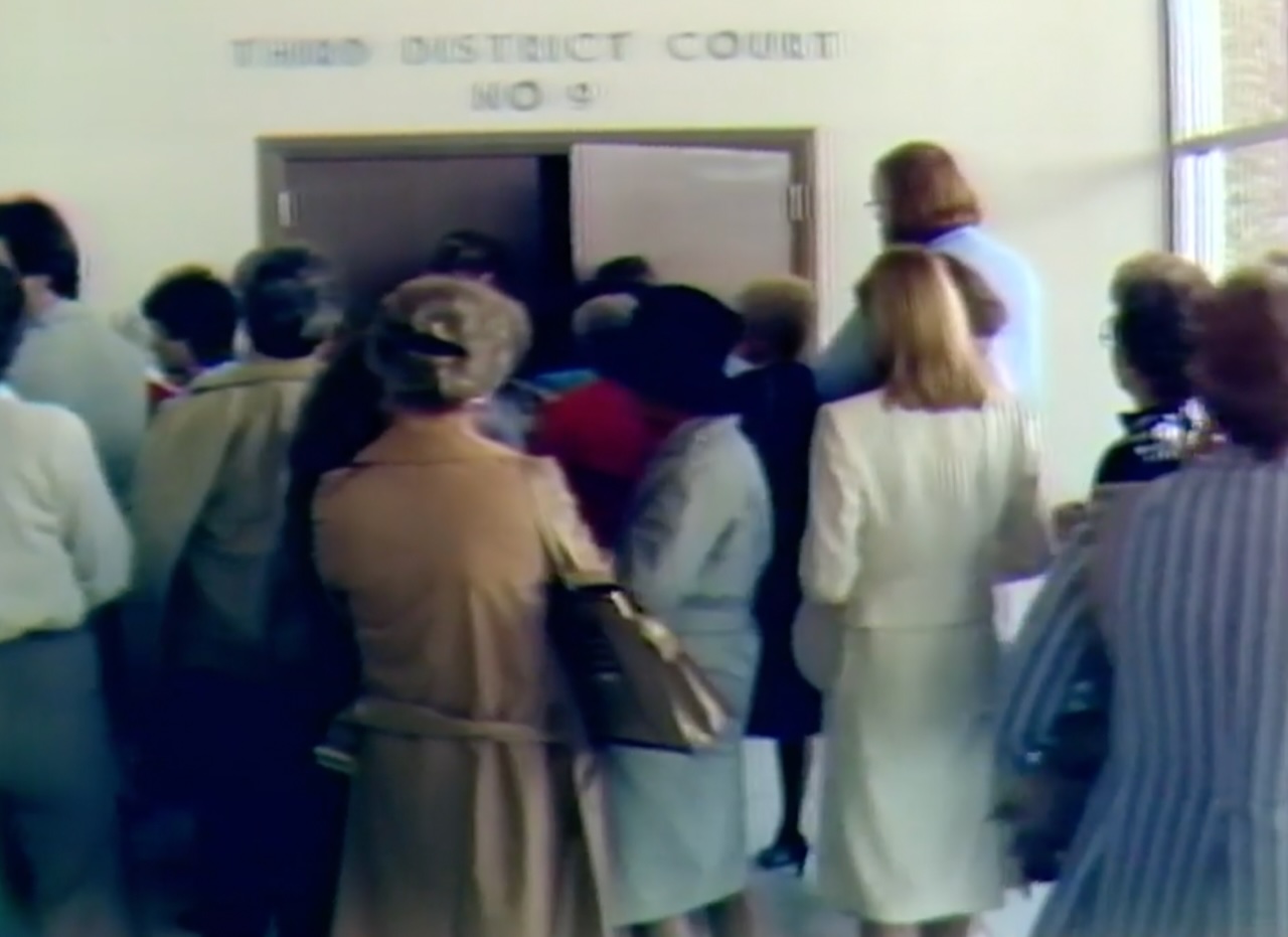 People enter a 3rd District courtroom for the murder trial of Michael Moore on Sept. 15, 1982.