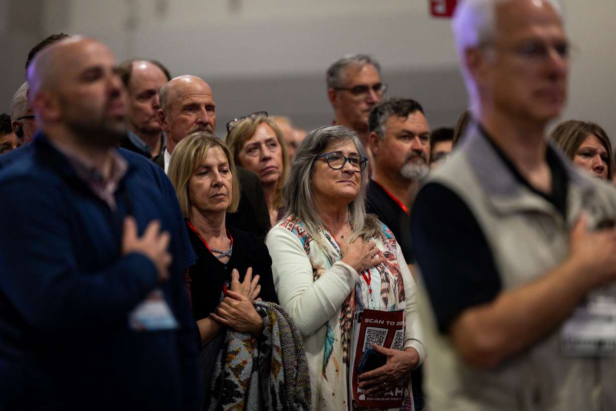 Attendees put their hands over their hearts during the performance of the national anthem at the Utah Republican Party state nominating convention at the Salt Palace Convention Center in Salt Lake City on Saturday.