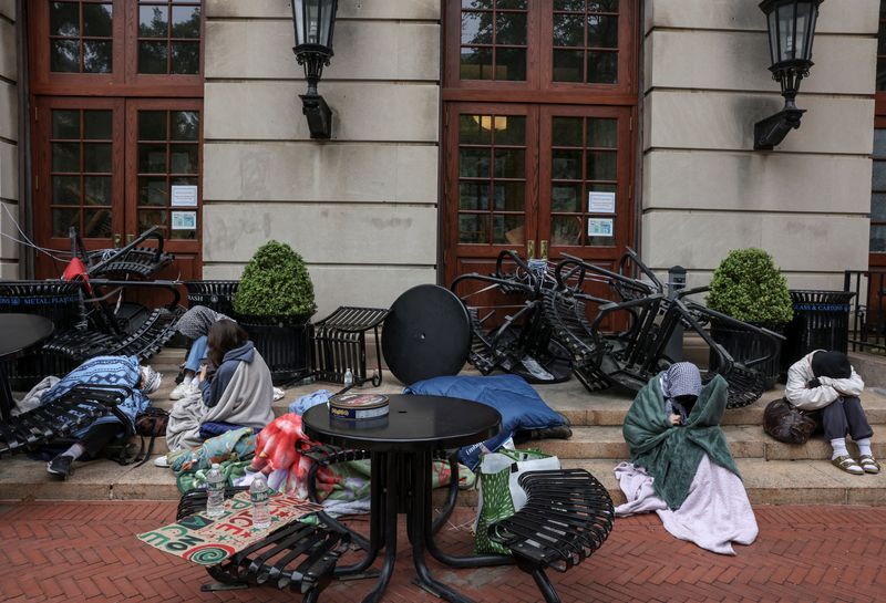 Student protesters sit and watch outside Hamilton Hall, which student protesters barricaded, near a protest encampment in support of Palestinians at Columbia University, despite orders from university officials to disband or face suspension, in New York City, Tuesday.