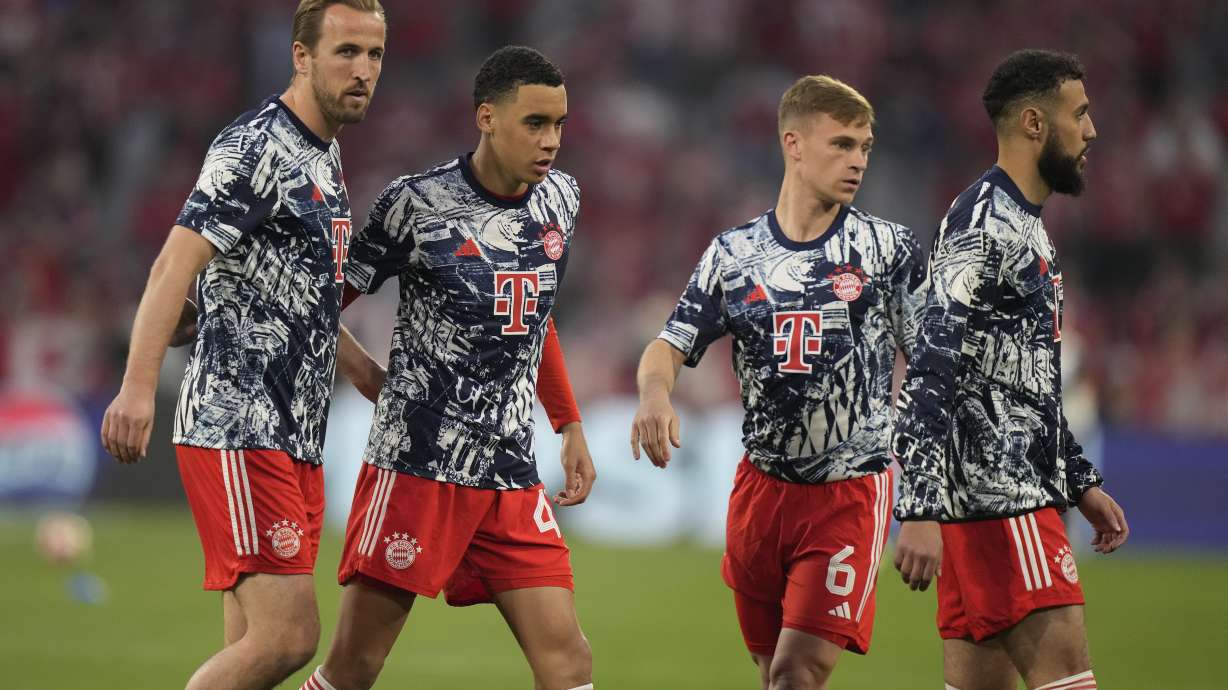 Bayern's Harry Kane, left, Bayern's Jamal Musiala, second left, Bayern's Noussair Mazraoui, right, and Bayern's Joshua Kimmich warm up prior to the Champions League semifinal first leg soccer match between Bayern Munich and Real Madrid at the Allianz Arena in Munich, Germany, Tuesday, April 30, 2024.
