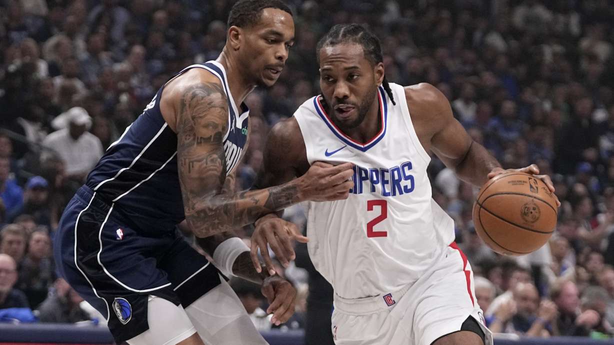 Dallas Mavericks forward P.J. Washington, left, defends as Los Angeles Clippers' Kawhi Leonard (2) works to the basket during the first half of Game 2 of an NBA basketball first-round playoff series Friday, April 26, 2024, in Dallas.