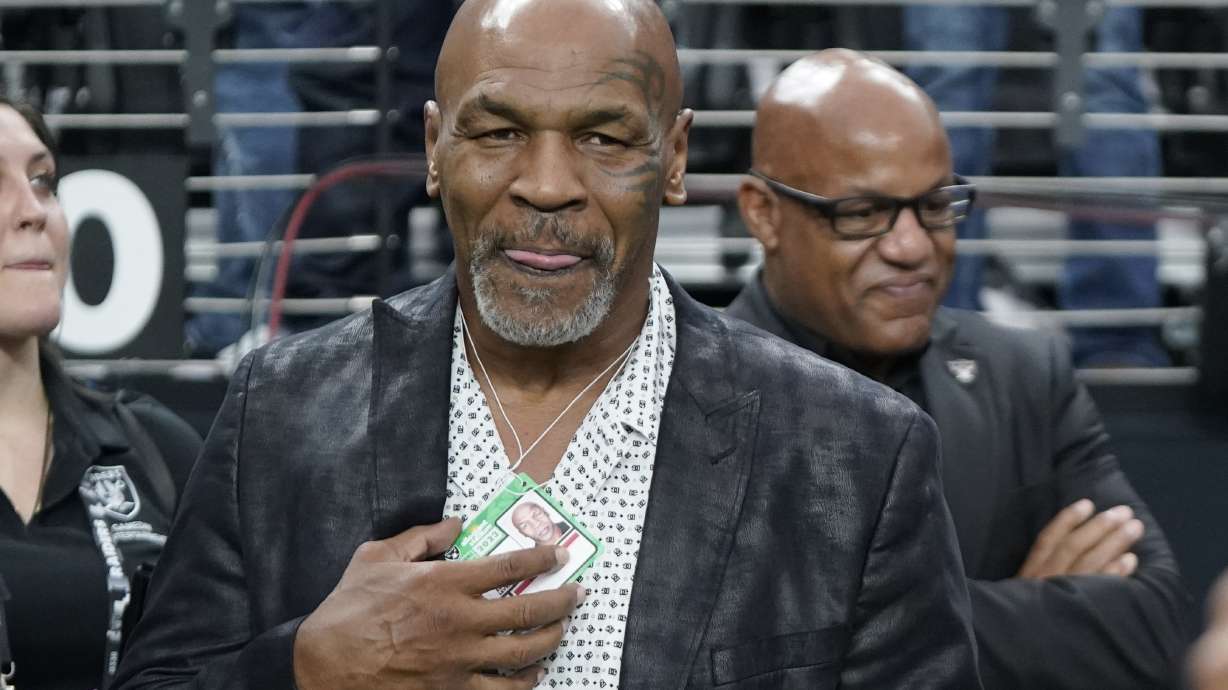 FILE - Former heavyweight boxing champion Mike Tyson stands on the field before an NFL football game between the Las Vegas Raiders and the Pittsburgh Steelers Sunday, Sept. 24, 2023, in Las Vegas. Tyson's fight against Jake Paul in Texas this summer has been sanctioned as a competitive boxing match rather than an exhibition, and the rounds will be shorter and the gloves will be heavier. The Texas Department of Licensing and Regulation this week approved terms for the July 20 fight at AT&T Stadium in Arlington.