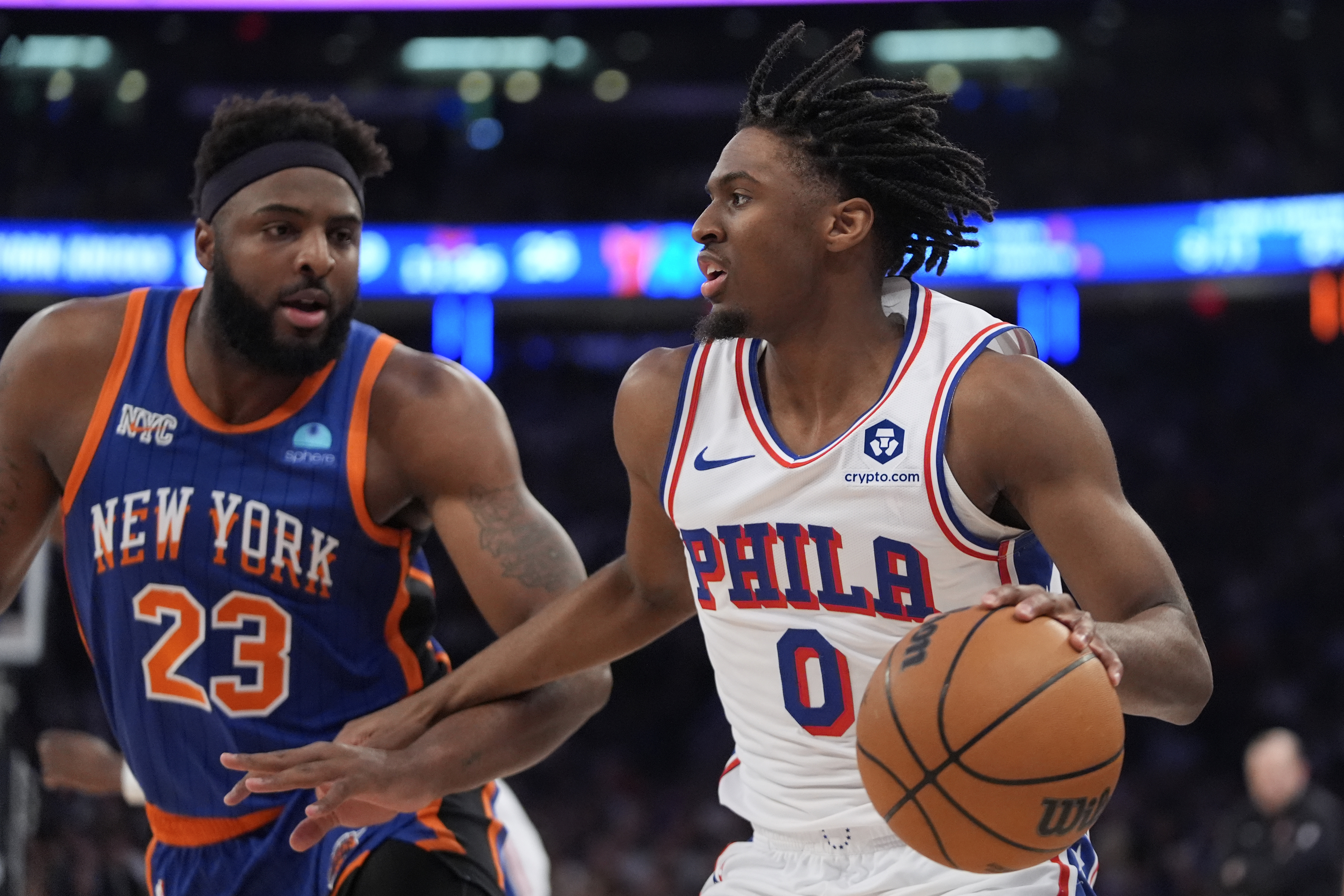 Philadelphia 76ers' Tyrese Maxey (0) looks to pass as New York Knicks' Mitchell Robinson (23) defends during the first half of Game 5 in an NBA basketball first-round playoff series, Tuesday, April 30, 2024, in New York.