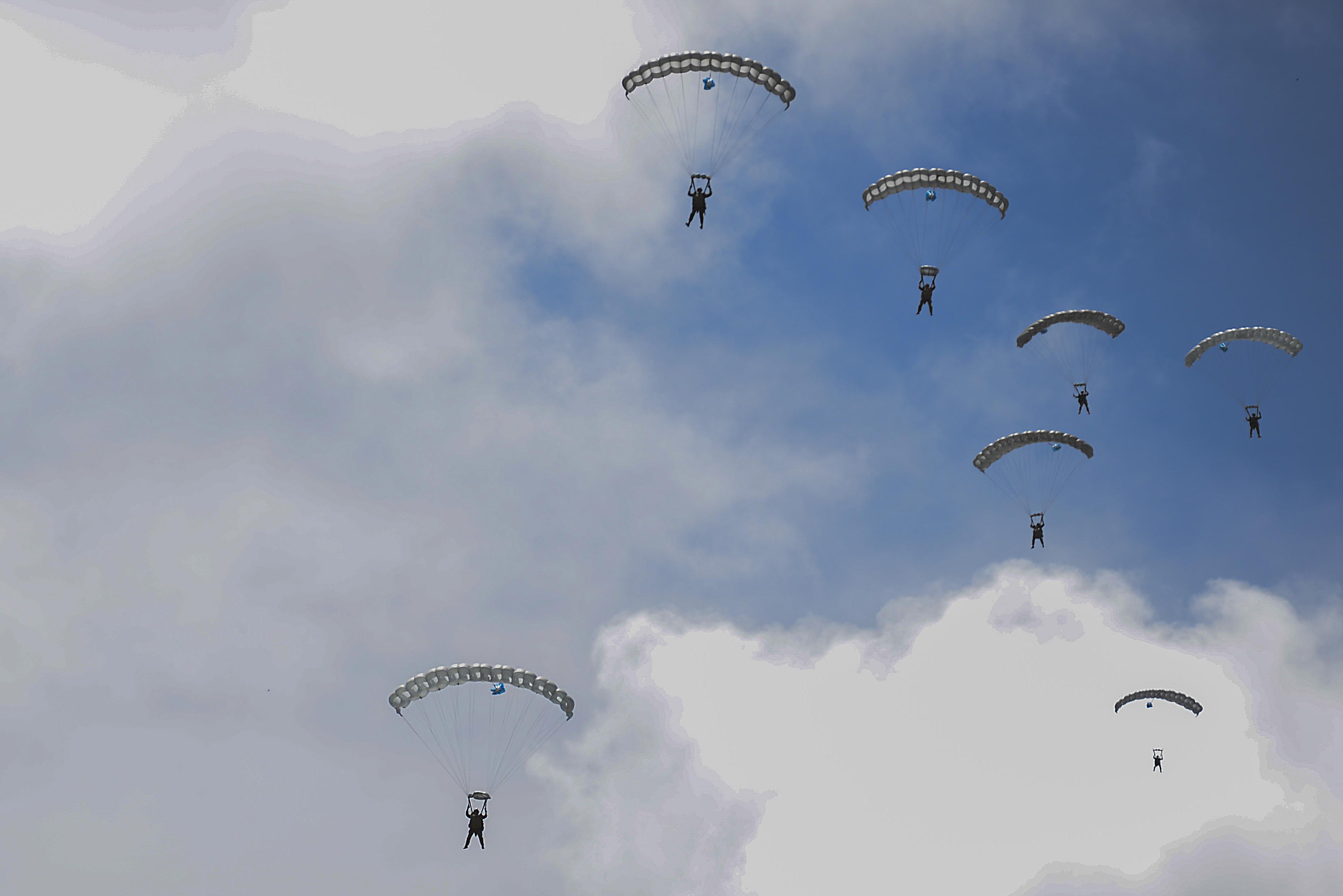 Marines jump from an MC-130J Commando II during an airfield seizure exercise at Wake Island on Aug. 24, 2016.