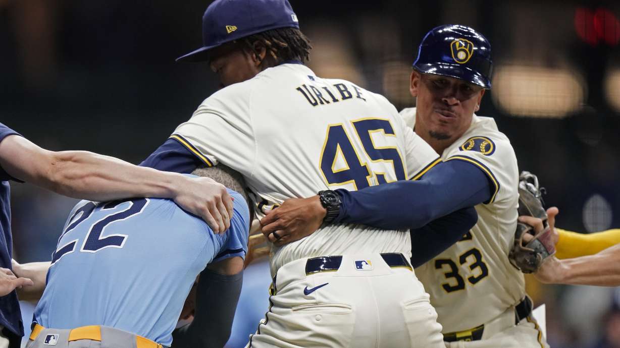 Milwaukee Brewers' Abner Uribe (45) is held back by Quintin Berry (33) as he fights with Tampa Bay Rays' Jose Siri (22) during the eighth inning of a baseball game Tuesday, April 30, 2024, in Milwaukee.