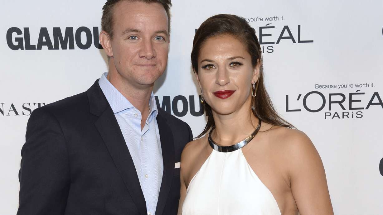 FILE - Brian Hollins, left, and Carli Lloyd attend the 25th annual Glamour Women of the Year Awards at Carnegie Hall on Monday, Nov. 9, 2015, in New York. Retired U.S. women's soccer star Carli Lloyd and her husband are expecting their first child in October. The 41-year-old Lloyd announced her pregnancy on Instagram on Wednesday, May 1, 2024. She has been married to Brian Hollins for seven years