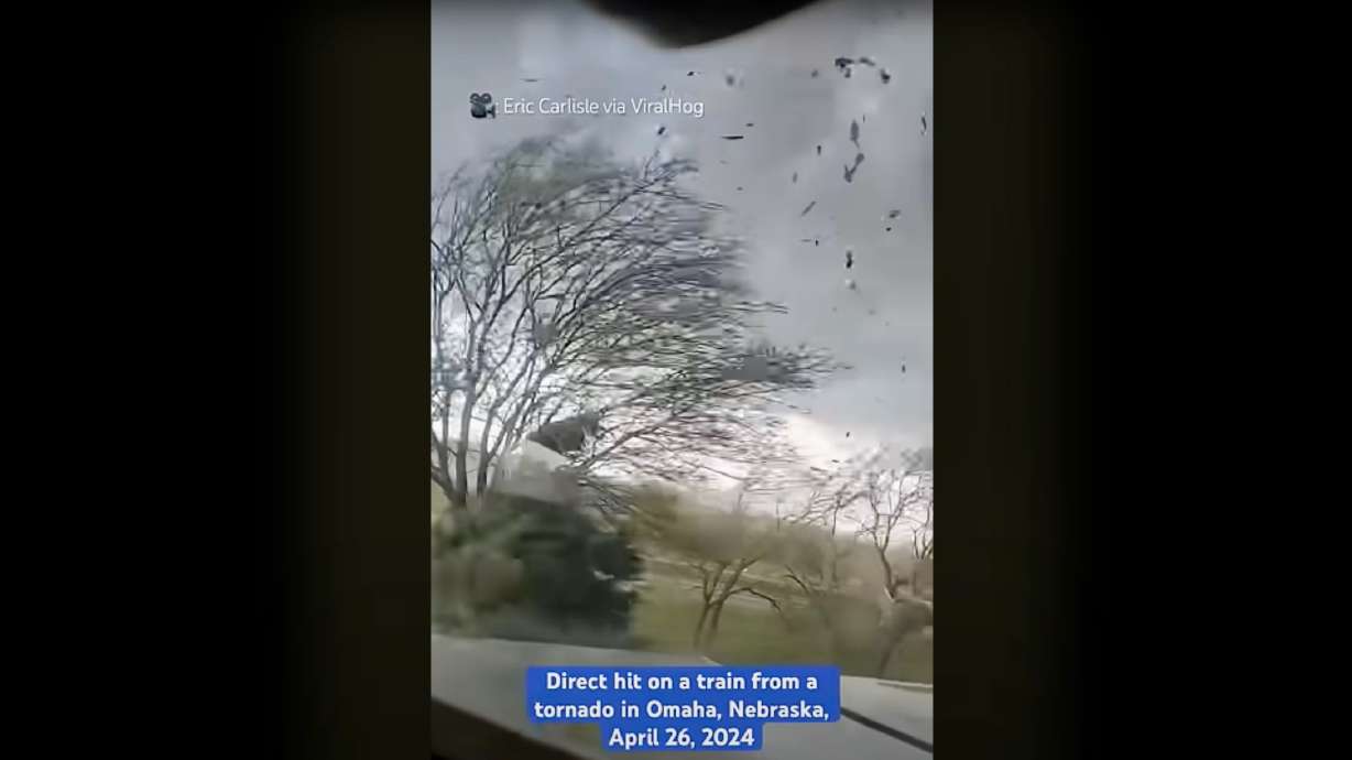 A tornado nears a train engine stopped near Waverly Nebraska. The tornado struck on April 26 and passed over the train.
