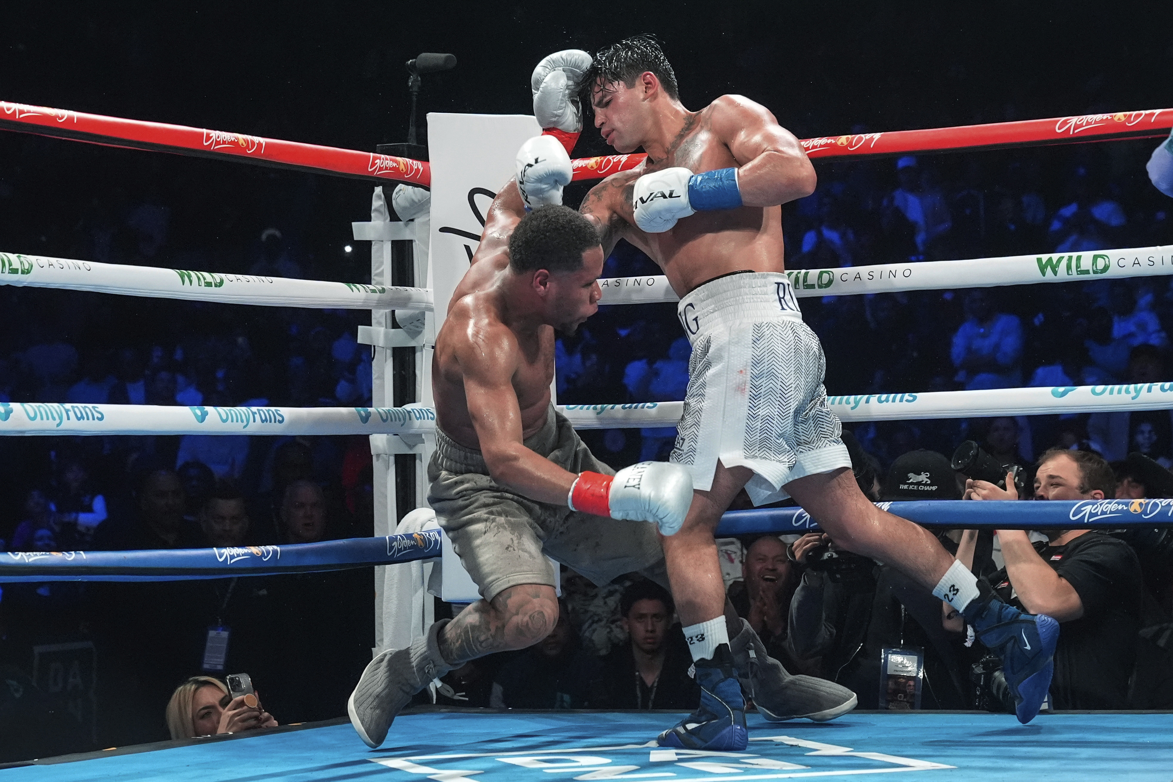 Ryan Garcia, right, knocks down Devin Haney during the 10th round of a super lightweight boxing match early Sunday, April 21, 2024, in New York. Garcia won the fight.