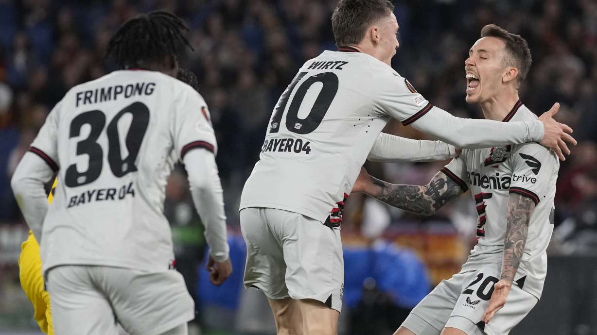 Leverkusen's Florian Wirtz, center, celebrates after scoring his side's opening goal with his teammates during the Europa League semifinal first leg soccer match between Roma and Bayer Leverkusen at Rome's Olympic Stadium in Rome, Italy, Thursday, May 2, 2024.