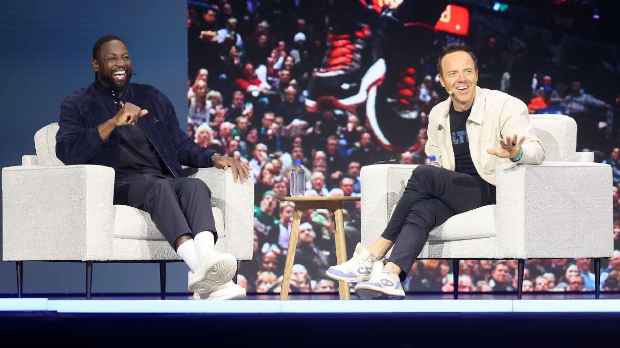 Dwyane Wade, former NBA player and Utah Jazz minority owner, and Ryan Smith, Qualtrics co-founder and Utah Jazz majority owner, talk at the Qualtrics X4 Tech Summit at the Salt Palace Convention Center in Salt Lake City on Thursday.