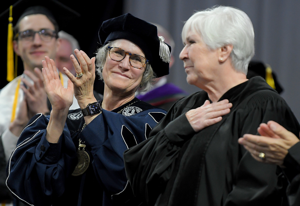 President Elizabeth "Betsy" Cantwell, left, applauds after Gail Miller gave the commencement address to graduates at Utah State University on Thursday in Logan.