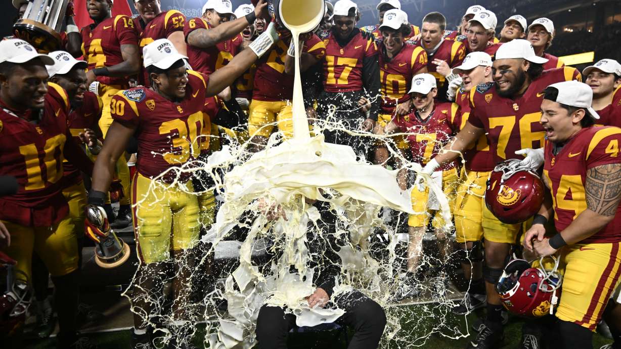 FILE - Southern California coach Lincoln Riley has eggnog poured onto him after USC defeated Louisville in the Holiday Bowl NCAA college football game, Wednesday, Dec. 27, 2023, in San Diego. With the expanded College Football Playoff locked in through 2031, questions still remain about what the rest of the postseason will look like. One thing is certain, there will still be bowl games.