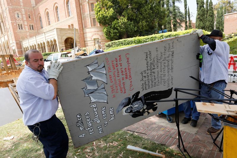Workers remove the barricades of a protest encampment in support of Palestinians, that was broken down by police the previous night on the campus of University of California Los Angeles in L.A. on Thursday.