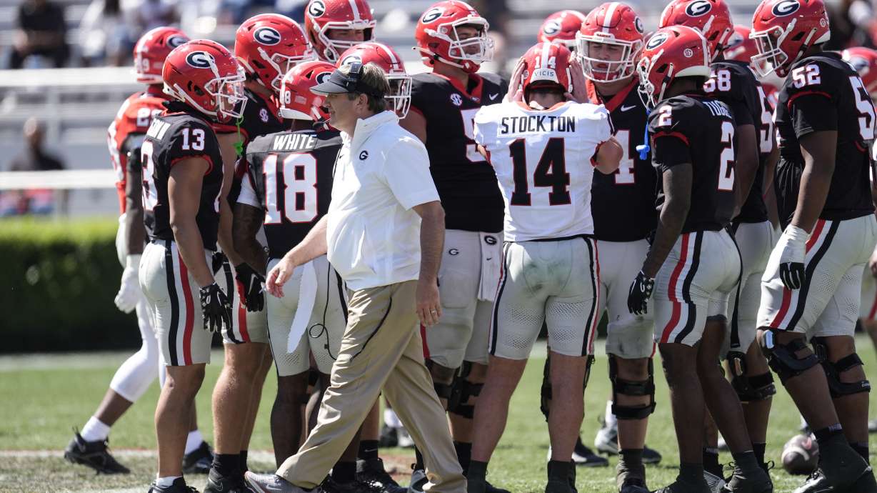 Georgia head coach Kirby Smart walks past the Black Team huddle during the second half of an NCAA college spring football game Saturday, April 13, 2024, in Athens, Ga.