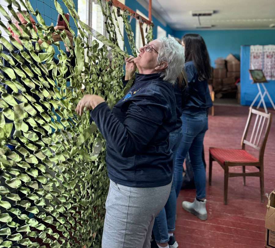 Idaho mother Terri Hepworth helped with a camouflage net on a humanitarian trip to Ukraine in this undated photo.