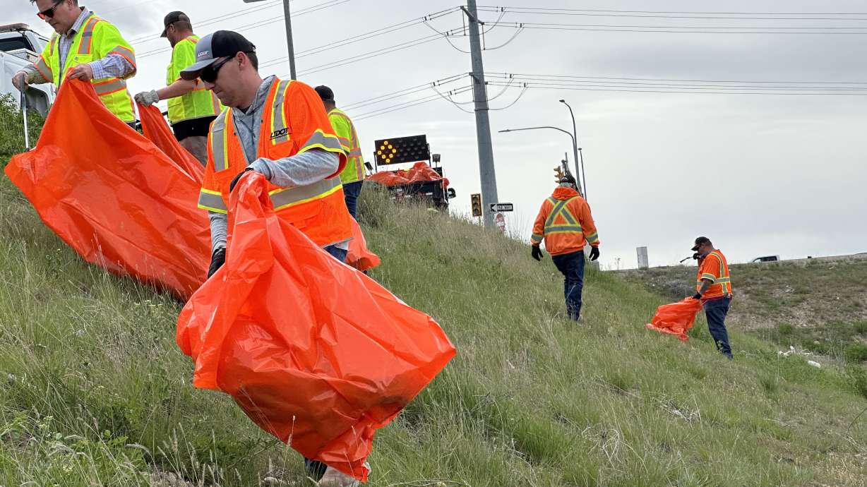 Utah Department of Transportation maintenance workers clean up trash from the shoulders of Mountain View Corridor and state Route 201 on Thursday. The event helped kick off the state's new litter-cleanup program called Keeping Utah Beautiful.
