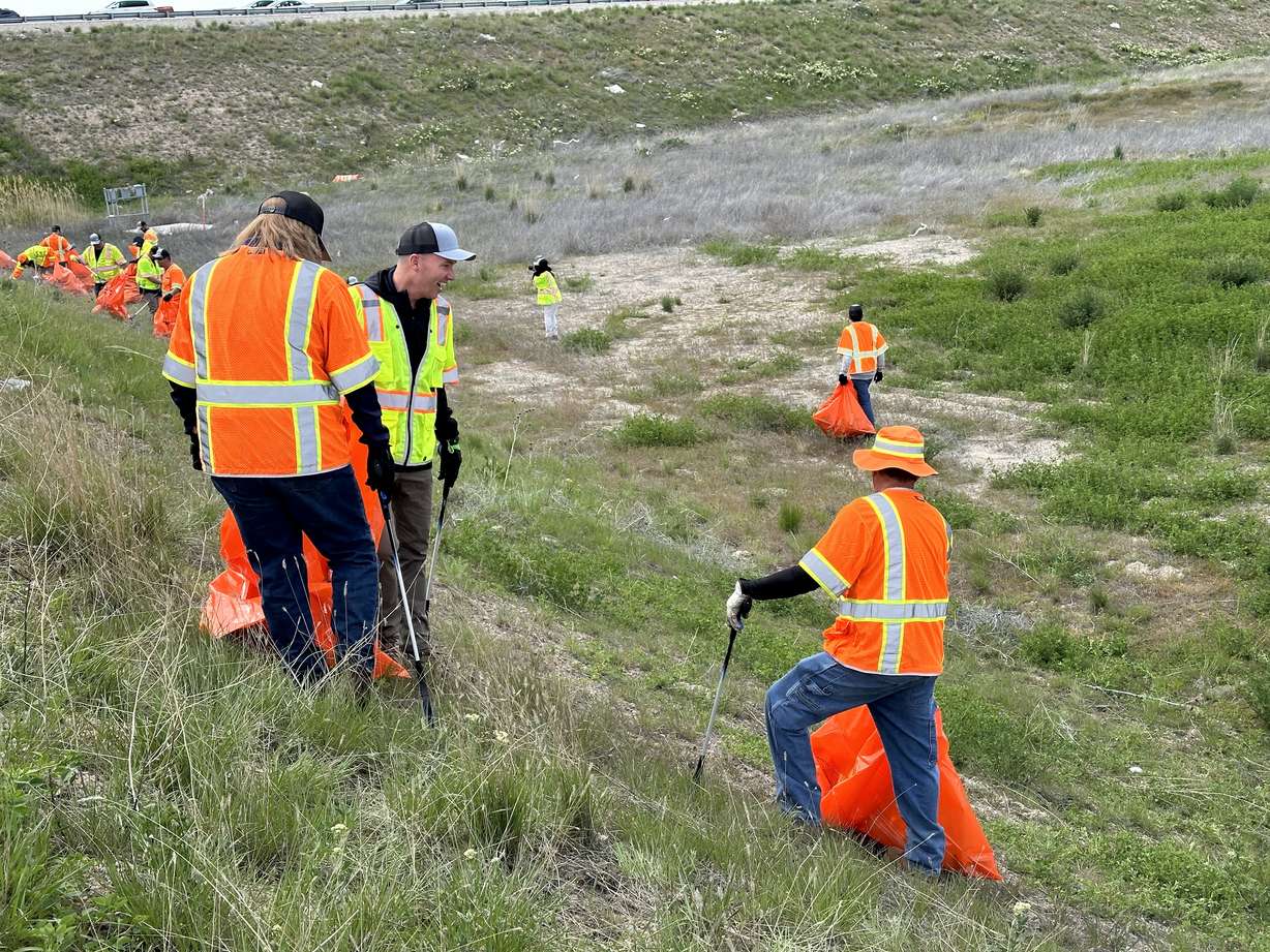 Gov. Spencer Cox and UDOT maintenance workers clean up trash off of Mountain View Corridor and state Route 201 Thursday.