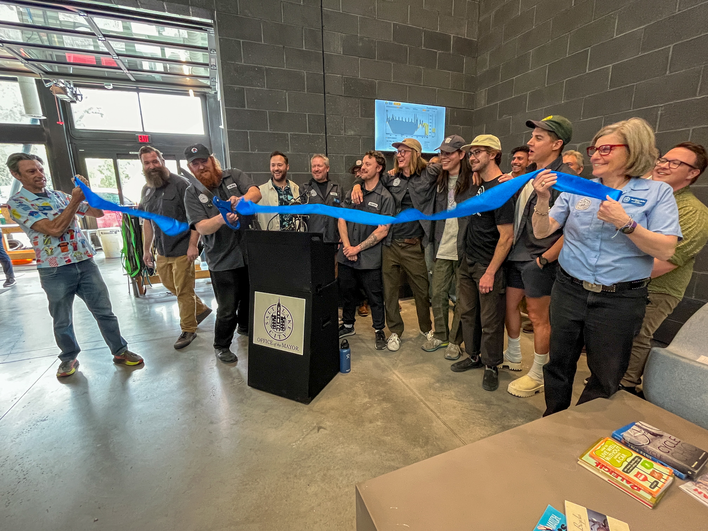 Bicycle Collective and Salt Lake City leaders cut a ribbon to signal the opening of the Bicycle Collective's new flagship location in Salt Lake City on Thursday.