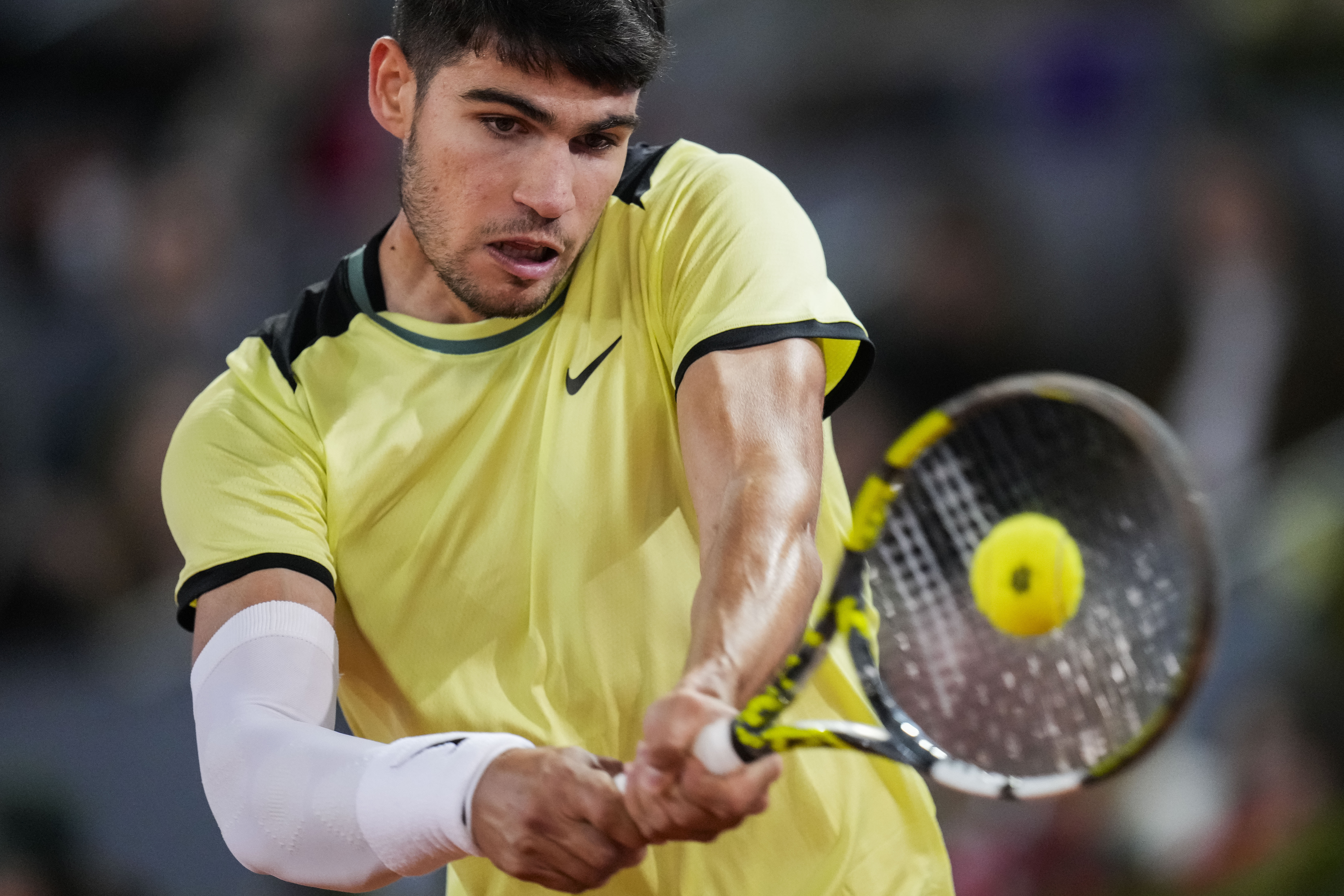 Carlos Alcaraz, of Spain, returns the ball to Andrey Rublev, of Russia, during the Mutua Madrid Open tennis tournament in Madrid, Wednesday, May 1, 2024.