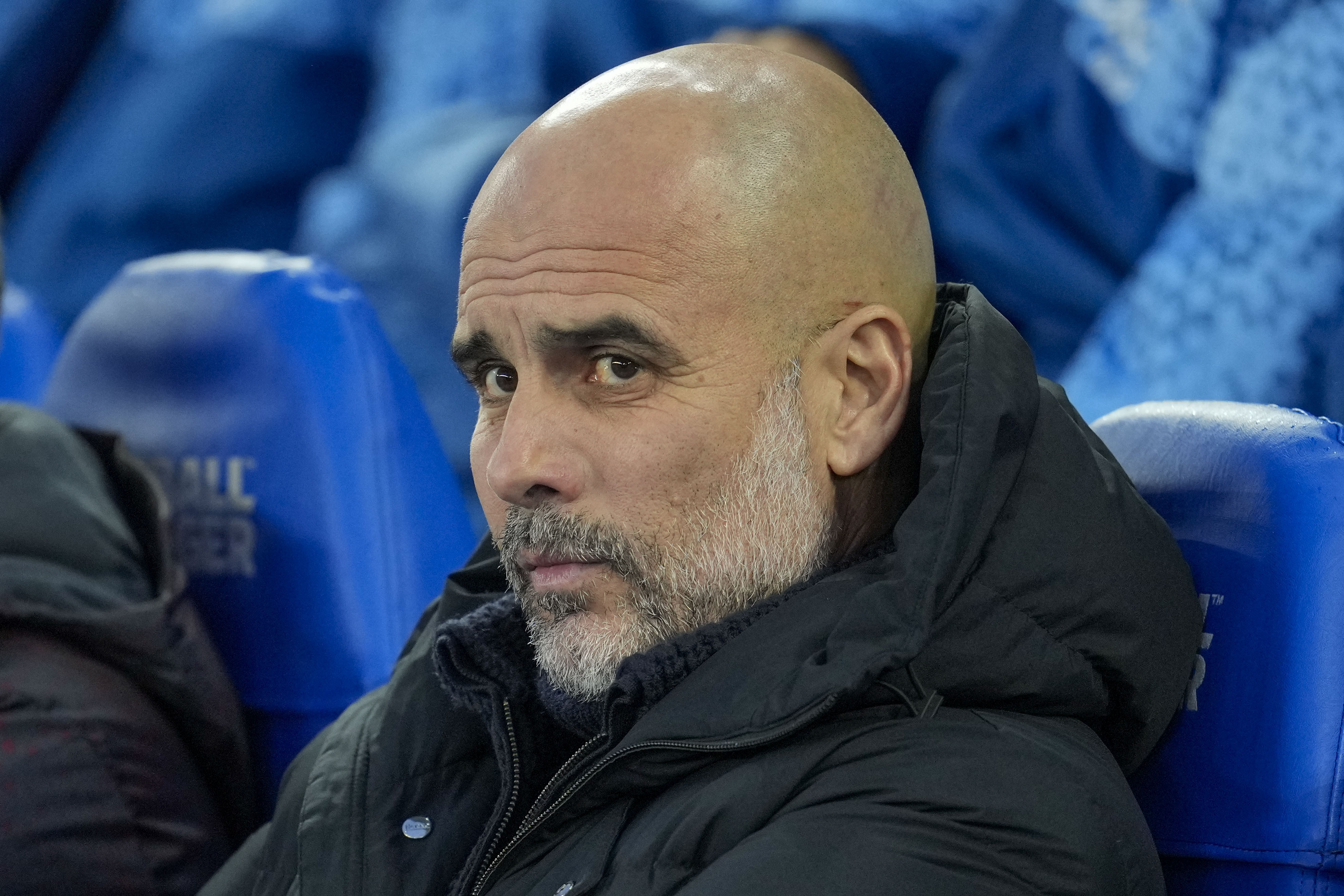 Manchester City's head coach Pep Guardiola looks out from the bench prior the English Premier League soccer match between Brighton and Manchester City at the Falmer Stadium in Brighton, England, Thursday, April 25, 2024.