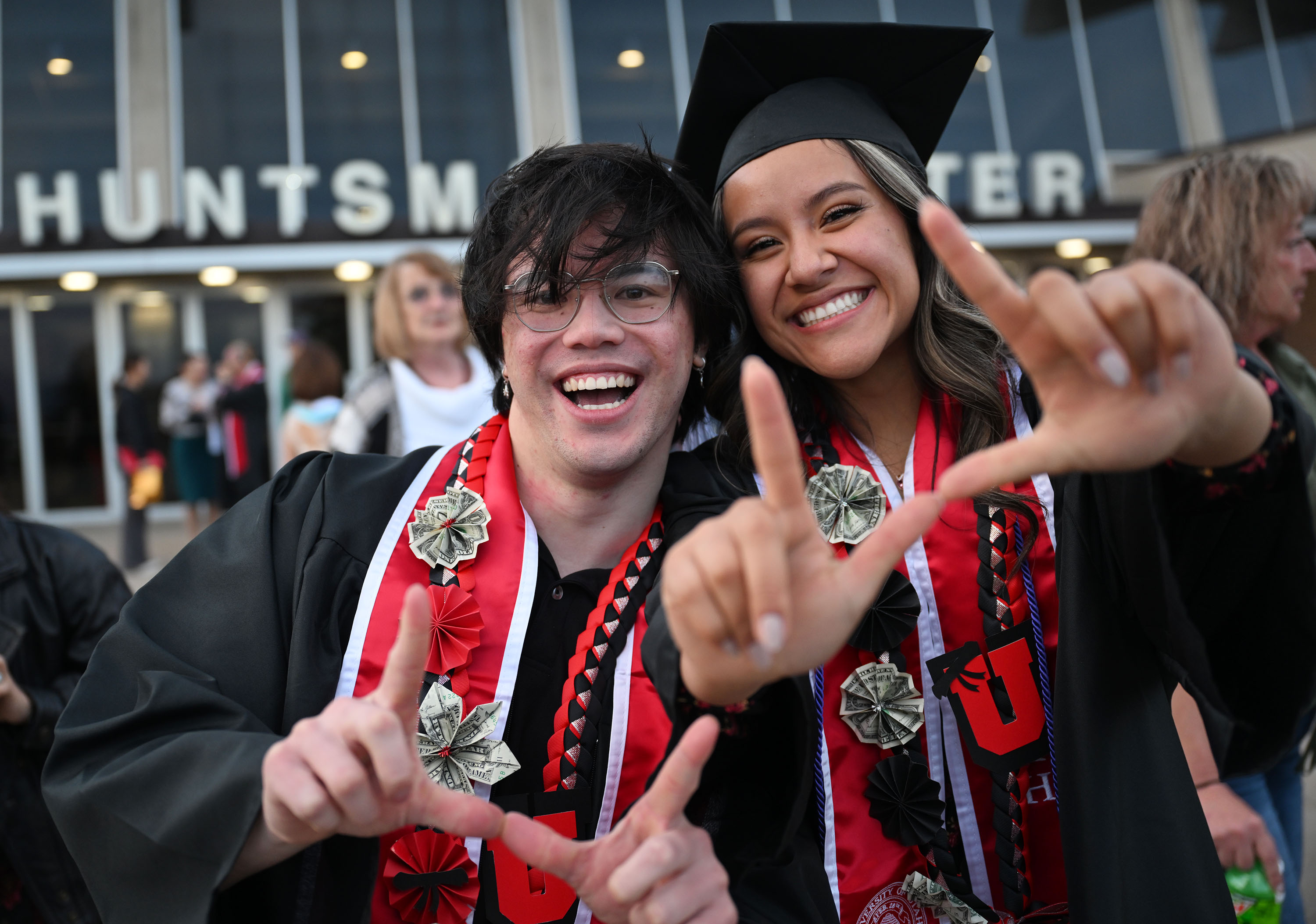 Jack Rogers and Emily Meza hold up their U’s after commencement ceremonies at the University of Utah in Salt Lake City on Thursday.