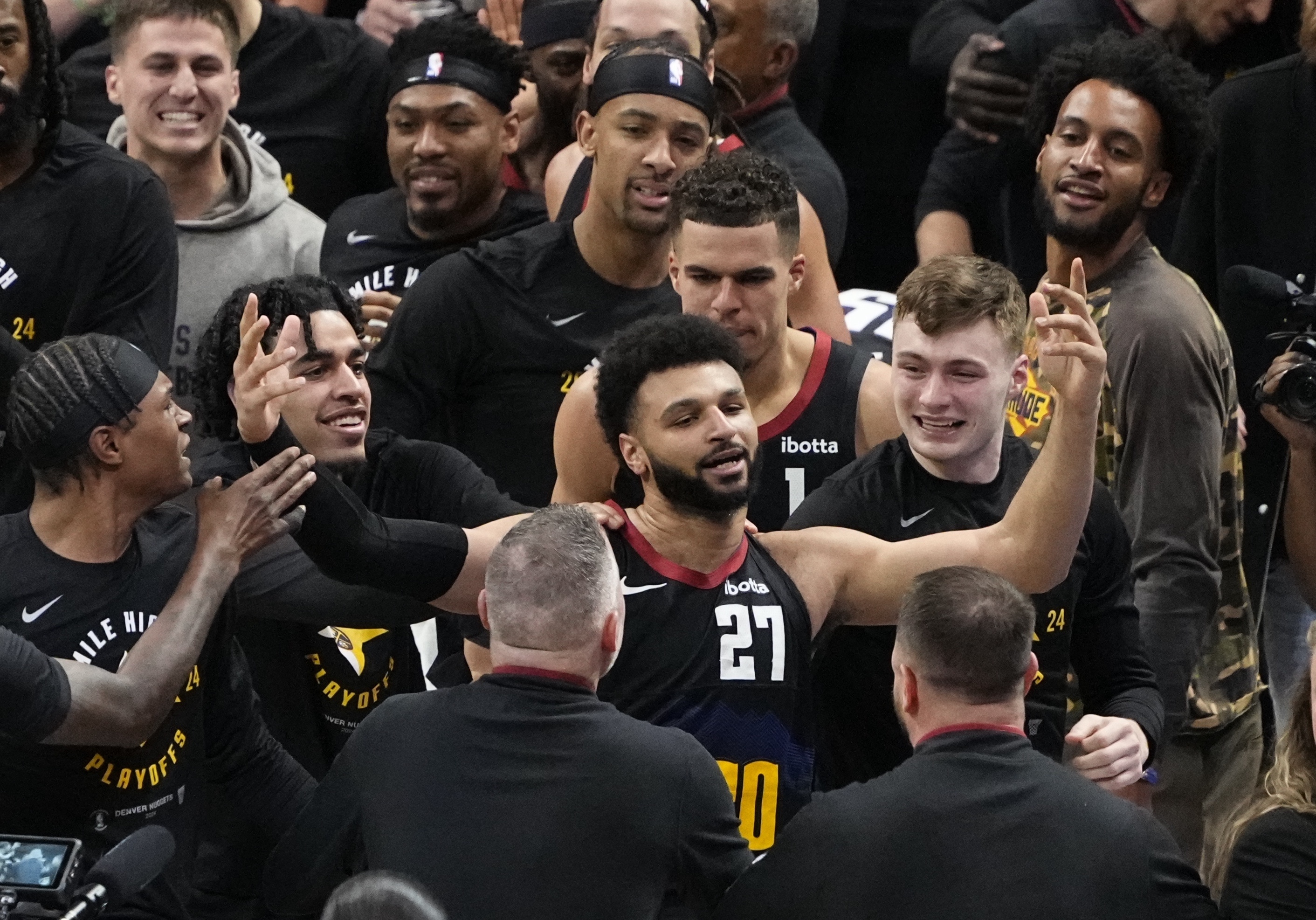 Denver Nuggets guard Jamal Murray (27) is congratulated by teammates after hitting the game-winning basket at the buzzer against the Los Angeles Lakers during the second half in Game 2 of an NBA basketball first-round playoff series Monday, April 22, 2024, in Denver.