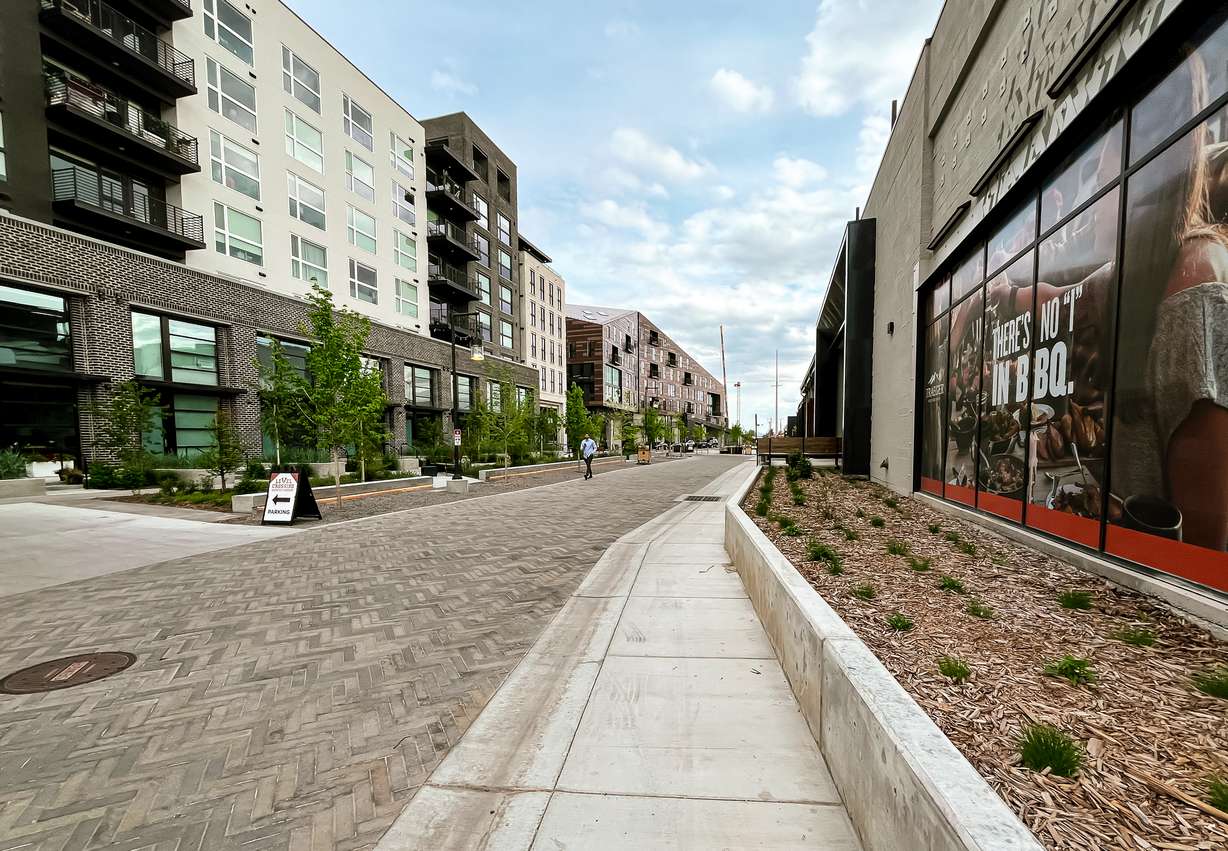 A mid-block road and walkway separating housing units and the Traeger Grills headquarters within the Post District is pictured on Thursday.