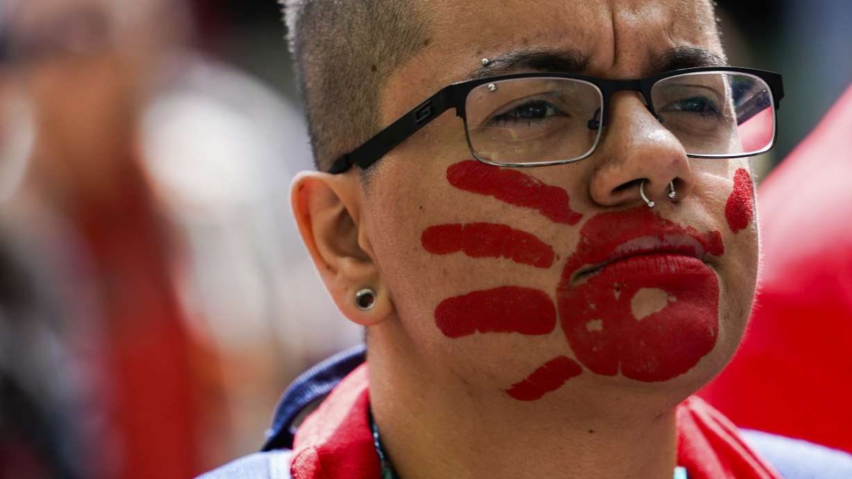 A marcher wears a red handprint on their face during the third annual march and gathering for Missing and Murdered Indigenous Women, People and Families on May 6, 2023, in Seattle.