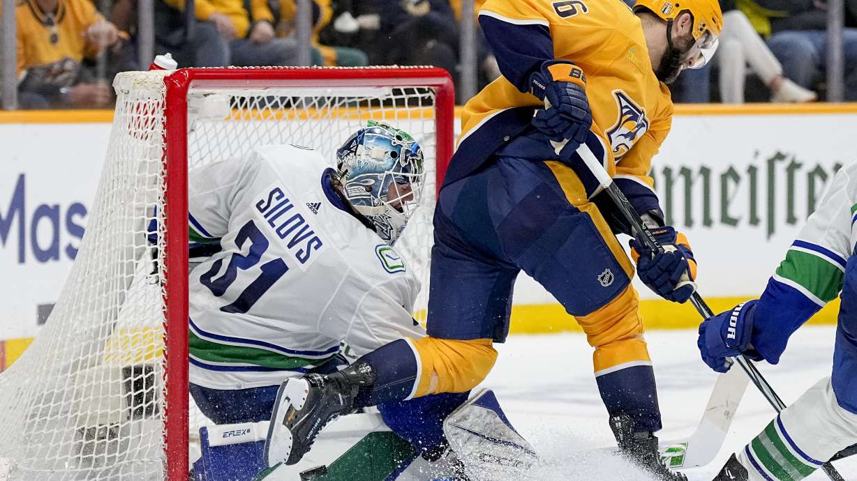 Vancouver Canucks goaltender Arturs Silovs (31) blocks a shot on goal by Nashville Predators left wing Jason Zucker (16) during the second period in Game 6 of an NHL hockey Stanley Cup first-round playoff series Friday, May 3, 2024, in Nashville, Tenn.