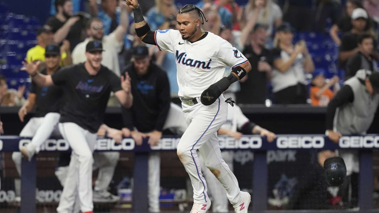 Miami Marlins' Luis Arraez scores the winning run on a hit by Jesús Sánchez during the 10 inning of a baseball game against the Colorado Rockies, Thursday, May 2, 2024, in Miami. The Marlins defeated the Rockies 5-4.
