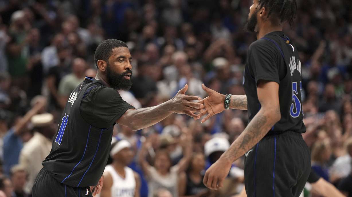 Dallas Mavericks guard Kyrie Irving (11) congratulates forward Derrick Jones Jr. (55) during the second half of an NBA basketball first-round playoff series against the Los Angeles Clippers Friday, May 3, 2024, in Dallas.
