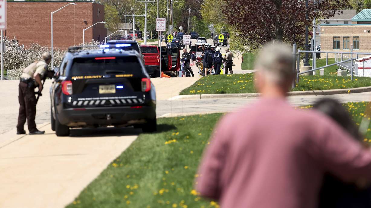 Law enforcement personnel respond to a report of a person armed with a rifle at Mount Horeb Middle School in Mount Horeb, Wis., Wednesday. Authorities say a student who was killed by police outside a Wisconsin school pointed a pellet rifle at officers and had refused to drop the weapon.